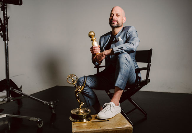 Photo of Andrew Barnsley with his Emmy and Golden Globe awards