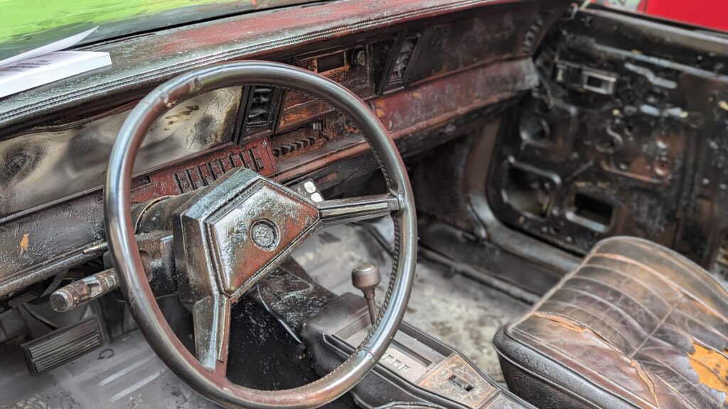 Image of interior of burned out car for the premiere of the documentary I Like Me. Film reviewed by Garry Murdock. 