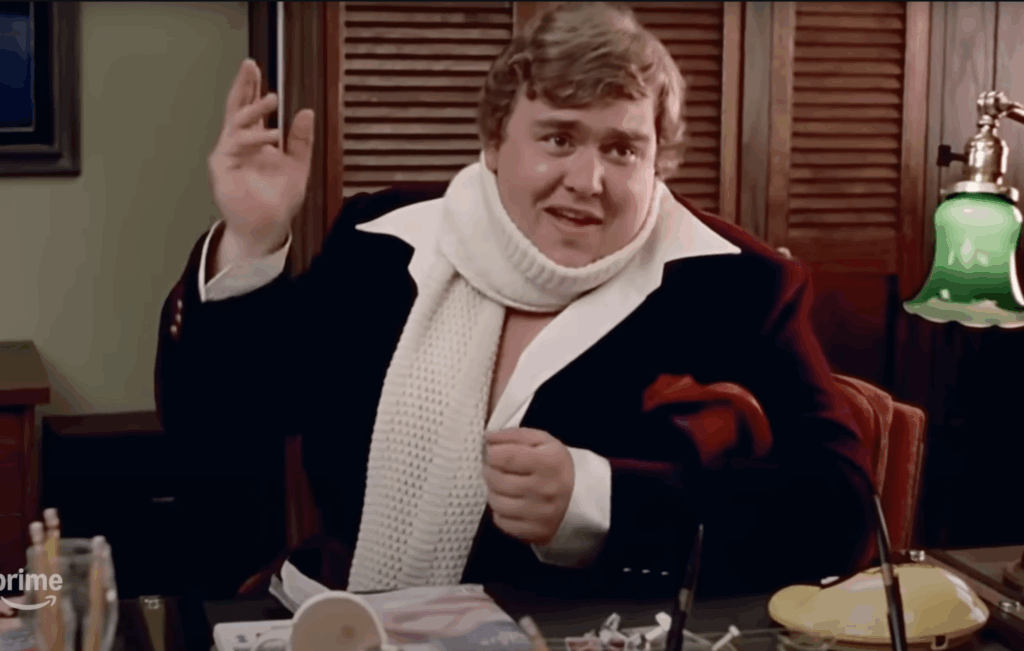 Image of John Candy in red jacket and white scarf from the movie Splash.