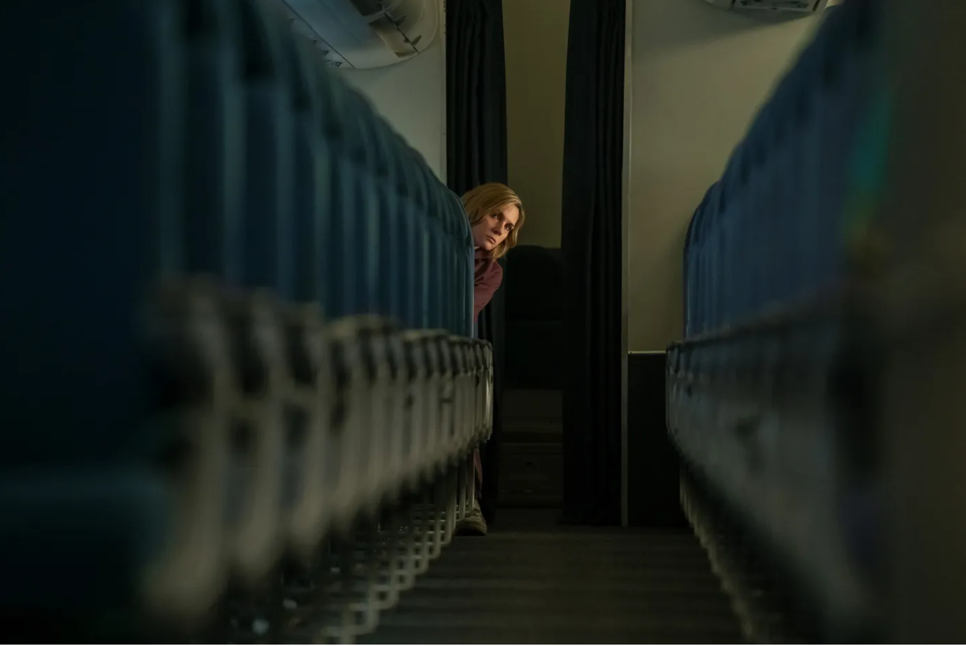 Carol is sitting in plane seat. She is the only passenger in this scene from Pluribus.
