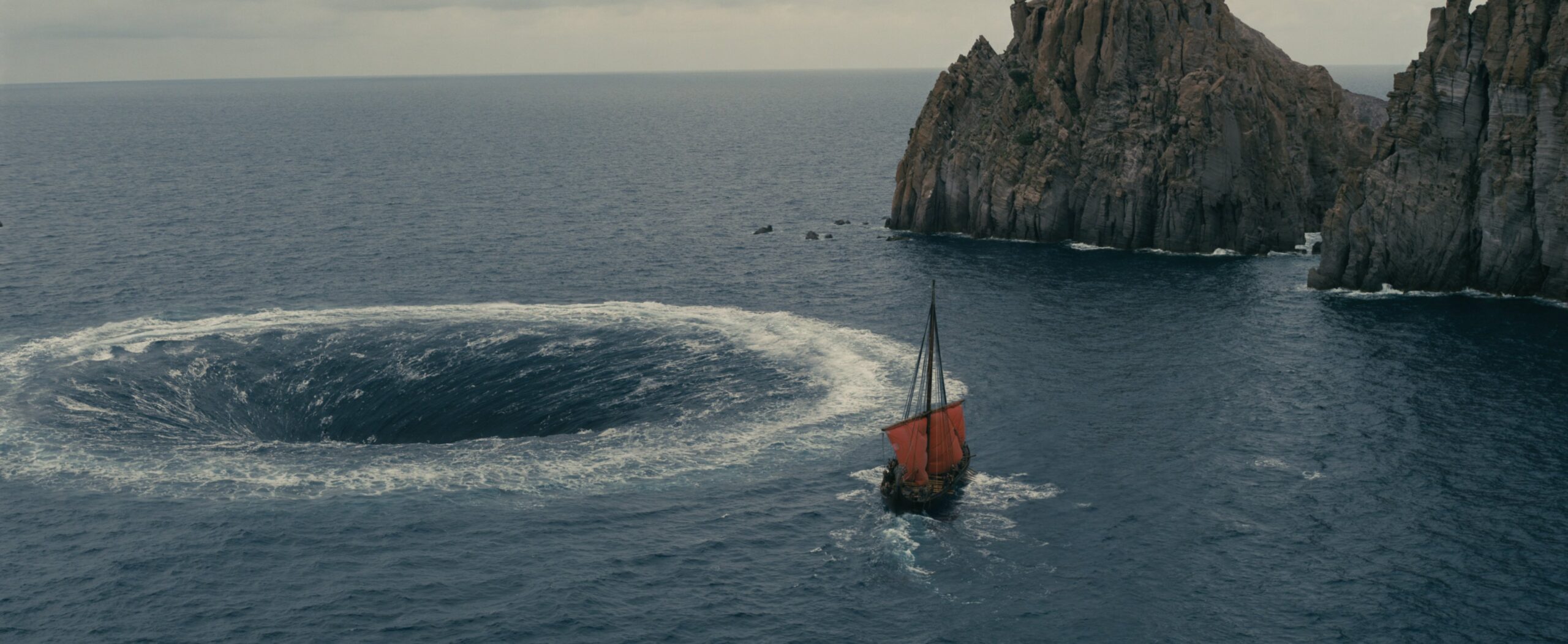 Image of ship at sea, being dragged down by a swirling hole.