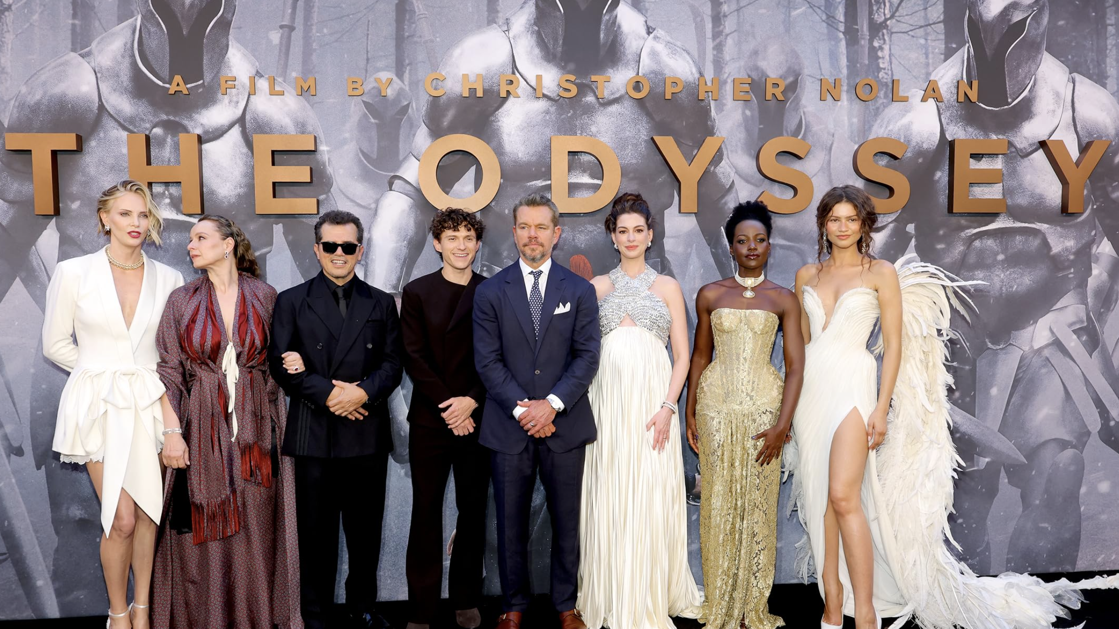 Image of some of the cast of The Odyssey. From left to right: Charlize Theron, Samantha Morton, John Leguizamo, Tom Holland, Matt Damon, Anne Hathaway, Lupita Nyong'o, Lupita Nyong'o, and Zendaya.