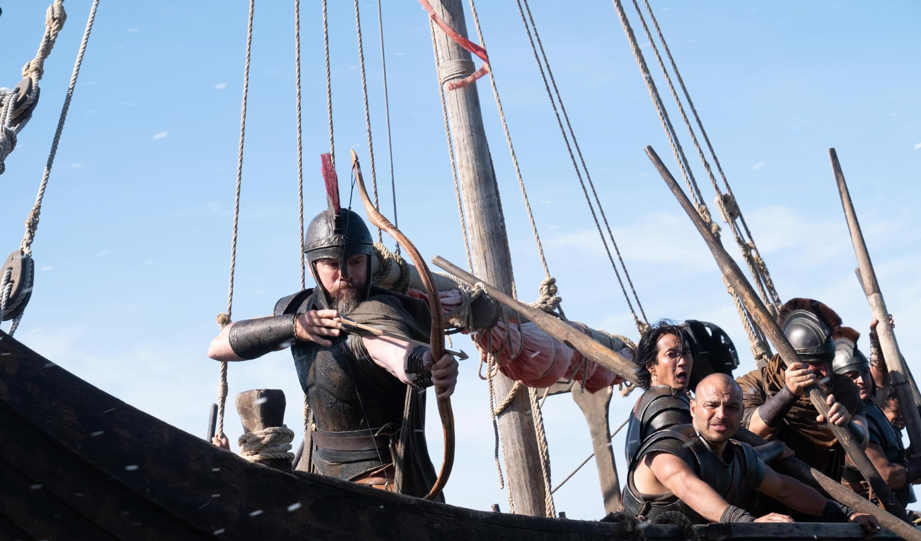 Image of Odysseus firing bow and arrow, on ship with his men. 