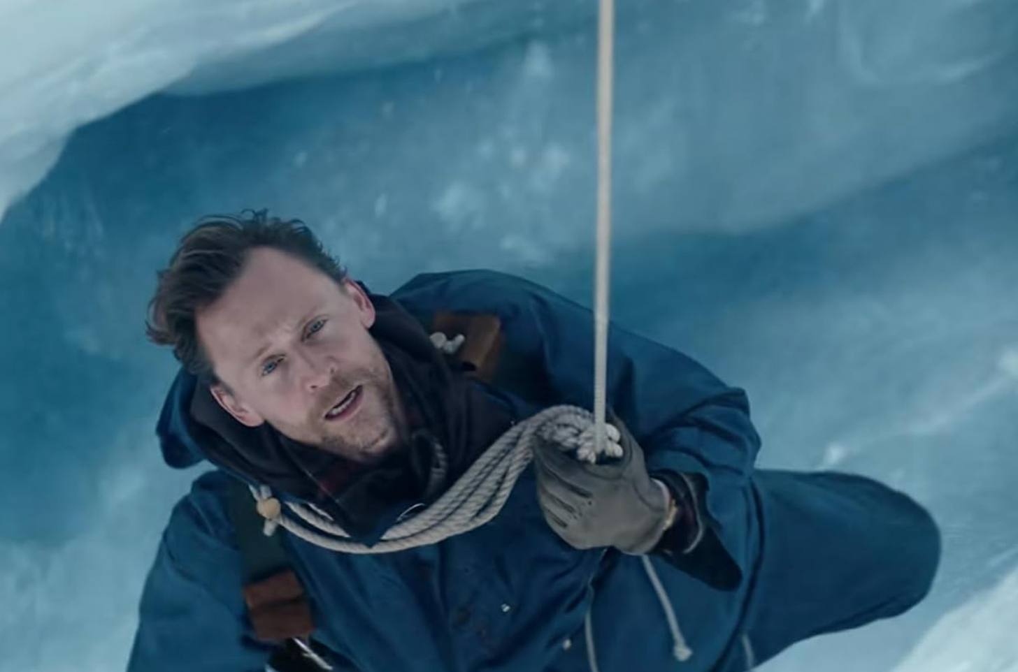 Image of Tom Hiddleston, caught in a crevice as he tries to climb Mount Everest.